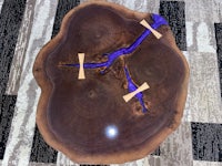 a coffee table with a piece of wood and a blue ribbon